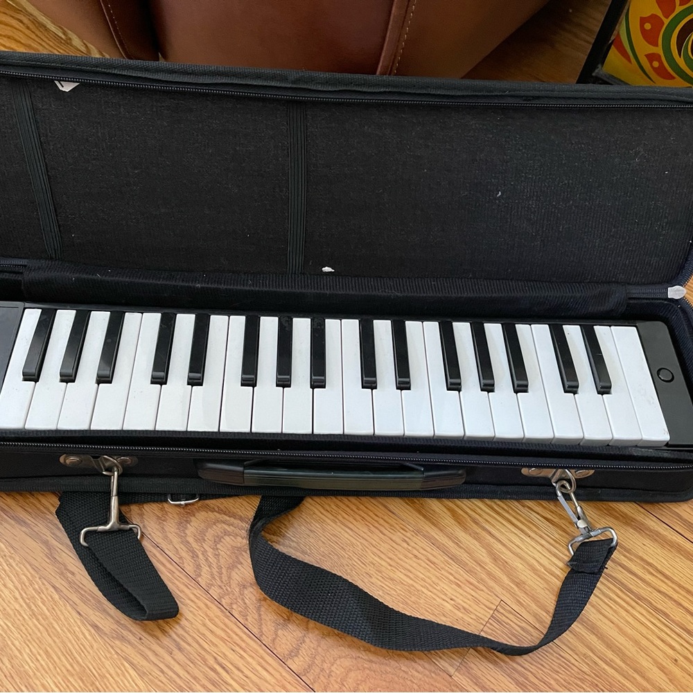 Melodica musical instrument-blow into mouthpiece while you play the keyboard